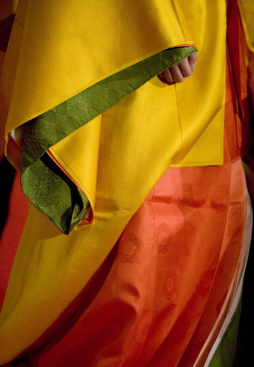 The hand of a model is barely seen under her layered sleeve during a demonstration Monday, July 7, 2008, of Junihitoe, 12-layered Ancient Kimono, for the G-8 spouses in Toyako, Japan. Junihitoe means 12 layers and is an example of the formal court dress worn by women during the Heian period (790-1185). Women were hidden behind screens at court and an occasional glimpse of their layered sleeves and hems was all that would be visible to a visitor or a suitor. White House photo by Shealah Craighead