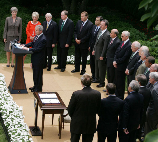 President George W. Bush, joined by members of his Cabinet and members of Congress, addresses his remarks Thursday, July 10, 2008, prior to signing the FISA Amendments Act of 2008 in the Rose Garden at the White House. White House photo by Joyce N. Boghosian