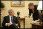 President George W. Bush confers with White House Press Secretary Tony Snow in the Oval Office in this Sept. 14, 2006 White House photo. The 53-year-old former spokesman died Saturday, July 12, 2008. In a statement, the President said: "All of us here at the White House will miss Tony, as will the millions of Americans he inspired with his brave struggle against cancer." White House photo by Eric Draper