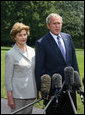 President George W. Bush and Mrs. Laura Bush meet with reporters Sunday, July 13, 2008 upon their arrival back to the White House, to express their sadness on the death of former White House Press Secretary Tony Snow. White House photo by Joyce N. Boghosian