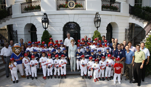 President George W. Bush and Mrs. Laura Bush stand with the All-Star Tee Ball teams and participants on the South Portico Wednesday, July 16, 2008, following a double-header at the White House, pitting Eastern U.S. against Central U.S. and Southern U.S. against Western U.S. White House photo by Eric Draper