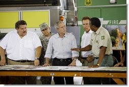 President George W. Bush, joined by California Governor Arnold Schwarzenegger, second from right, is briefed by U.S. Forest Service Regional Forester Randy Moore, right, Thursday, July 17, 2008 in Redding, Calif., during President Bush's tour to survey the wildfire damage in Northern California. White House photo by Eric Draper