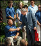 President George W. Bush shakes hands with Scott Winkler, 2008 U.S. Paralympics Track and Field team member, during a photo opportunity with the 2008 United States Summer Olympic Team Monday, July 21, 2008, in the Rose Garden of the White House. White House photo by Shealah Craighead