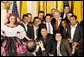 President George W. Bush poses for photos with entertainers Jorge Celedon, Jimmy Zambrano and their performance group during the celebration of Colombian Independence Day Tuesday, July 22, 2008, in the East Room of the White House. White House photo by Eric Draper