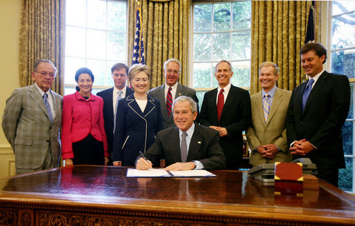President George W. Bush signs H.R. 3403, the New and Emerging Technologies 911 Improvement Act of 2008, Wednesday, July 23, 2008 in the Oval Office. President Bush is joined by from left, Alaska Senator Ted Stevens, Maine Senator Olympia Snowe, Federal Communications Commission Chairman Kevin Martin, New York Senator Hillary Rodham Clinton, Rep. John Shimkus, R-Ill., Rep. Bart Gordon, D-Tenn., Florida Senator Bill Nelson and Rep. Chip Pickering, R-Miss. White House photo by Joyce N. Boghosian