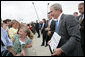 President George Bush holds a sign for a picture while greeting military personnel and families upon departure from the Greater Peoria Regional Airport - Air National Guard Ramp in Peoria, IL Friday, July 25, 2008. White House photo by Chris Greenberg
