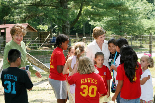 Mrs. Laura Bush, joined by North Carolina Senator Elizabeth Dole, left, greets Junior Ranger participates at a poetry reading event Monday, July 28, 2008, during a tour of the Carl Sandburg Home National Historic Site in Flat Rock, N.C. White House photo by Shealah Craighead