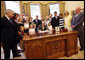 President George W. Bush signs the Caroline Pryce Walker Conquer Childhood Cancer Act of 2008 Tuesday, July 29, 2008, in the Oval Office of the White House. President Bush is joined at his desk by Mrs. Laura Bush, HHS Secretary Mike Leavitt, the Lewis family, the Adams family, the Haight family, the Rech family, and Congressional representatives Sen. Jack Reed D-RI; Minnesota Senator Norm Coleman; Rep. Deborah Pryce R-OH; and Rep. Chris Van Hollen D-MD; and CureSearch's Dr. Gregory Reaman. White House photo by Eric Draper