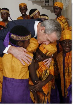 President George W. Bush embraces members of the African Children's Choir Wednesday, July 30, 2008, thanking them for their musical performance at the White House. White House photo by Eric Draper