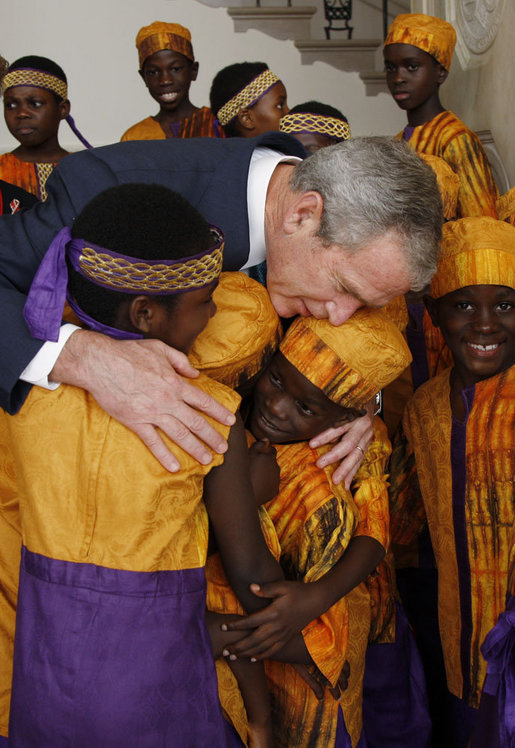 President George W. Bush embraces members of the African Children's Choir Wednesday, July 30, 2008, thanking them for their musical performance at the White House. White House photo by Eric Draper