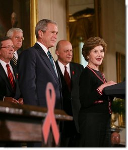  President George W. Bush is introduced to the podium by Mrs. Laura Bush Wednesday, July 30, 2008 in the East Room of the White House, prior to signing H.R. 5501, the Tom Lantos and Henry J. Hyde United States Global Leadership Against HIV/AIDS, Tuberculosis and Malaria Reauthorization Act of 2008.  White House photo by Joyce N. Boghosian