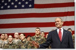 President George W. Bush waves to the crowd after arriving on stage Monday, Aug. 4, 2008, at Eielson Air Force Base, Alaska, where he addressed military personnel before continuing on to South Korea.  White House photo by Eric Draper