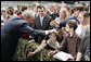 President George W. Bush pats the head of a youngster as he greets the crowd Monday, Aug. 4, 2008, after addressing military personnel at Eielson Air Force Base in Alaska. White House photo by Eric Draper