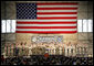 With an American flag as a backdrop, President George W. Bush addresses military personnel Monday, Aug. 4, 2008, during a stop in Alaska at Eielson Air Force Base, en route to South Korea. White House photo by Chris Greenberg
