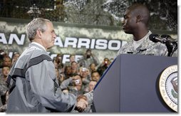President George W. Bush shakes hands with U.S. Army Cpl. Victor Berlus before delivering his remarks to the U.S. Army Garrison-Yongsan Wednesday, August 6, 2008, in Seoul, South Korea. White House photo by Eric Draper