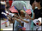 Children wave American and South Korean flags during the visit of President George W. Bush and Mrs. Laura Bush Wednesday, Aug. 6, 2008, to Seoul. White House photo by Eric Draper