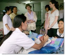 Mrs. Laura Bush and daughter Barbara Bush talk with a nurse Thursday, Aug. 7, 2008 at Mae Tao Clinic at the Mea La Refugee Camp which provides free treatment for the sick and wounded Burmese migrant workers in Mae Sot, Thailand.  White House photo by Shealah Craighead