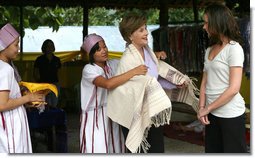 Mrs. Laura Bush and daughter Ms. Barbara Bush examine local wares after a dance ceremony and viewing traditional Karen weaving at the Mae La Refugee Camp at Mae Sot, Thailand, on Aug. 7, 2008. Mrs. Bush's visit to one of the largest refugee camps on the border was at the top of a mountain on the border with Burma. In her comments, Mrs. Bush noted the generosity of the Thai government and the people of Thailand in allowing the nine camps to exist there. White House photo by Shealah Craighead