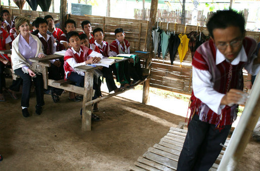 Mrs. Laura Bush sits in on a grammar class during her visit on Aug. 7, 2008 to the Mae La Refugee Camp at Mae Sot, Thailand. The camp, the largest of nine in Thailand, houses at least 39,000 Burmese refugees, many of whom home to resettle in the United States if conditions do not permit them to return to their home country. White House photo by Shealah Craighead