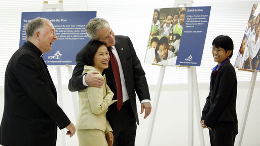 President George W. Bush embraces Usanee Janngeon, Executive Director of Mercy Centre, during a tour upon his arrival Thursday, Aug. 7, 2008, to The Human Development Foundation-Mercy Center, a non-profit organization to help educate and improve the health and welfare of poor children in Bangkok. The tour was led by Father Joe Maier, Director of The Human Development Center of Mercy Centre, left. White House photo by Eric Draper