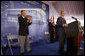 President George W. Bush acknowledges applause after being introduced by former President George H.W. Bush Friday, Aug. 8, 2008, during dedication ceremonies at the U.S. Embassy in Beijing. Said the President, "This has got to be a historic moment: father and son, two Presidents, opening up an embassy. I suspect it's the first, although I must confess I haven't done a lot of research into the itinerary of the Adams boys." White House photo by Eric Draper