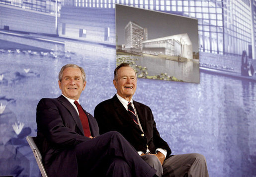 President George W. Bush and former President George H.W. Bush sit on stage at the U.S. Embassy in Beijing Friday, Aug. 8, 2008, during dedication ceremonies. Both are scheduled to attend opening ceremonies scheduled for later in the evening. White House photo by Eric Draper