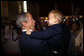 President George W. Bush plays with a young boy Friday, Aug. 8, 2008, during a greeting at the U.S. Embassy in Beijing. White House photo by Eric Draper