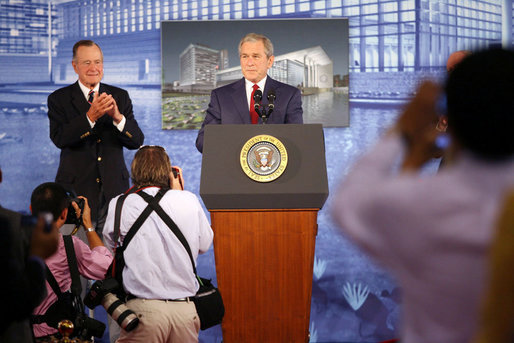 Former President George H.W. Bush leads the applause for his son, President George W. Bush after introducing him during dedication ceremonies Friday, Aug. 8, 2008, for the U.S. Embassy in Beijing. White House photo by Shealah Craighead