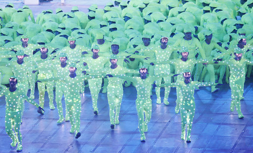 Performance artists wearing green illuminated costumes perform in National Stadium Friday evening, Aug. 8, 2008 in Beijing, during the Opening Ceremonies of the 2008 Summer Olympics. White House photo by Eric Draper