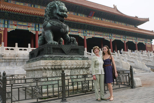 Mrs. Laura Bush and daughter Barbara Bush pause next to a Fu Dog during a visit Friday, Aug. 9, 2008, to the Forbidden City in Beijing. White House photo by Shealah Craighead