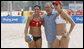 President George W. Bush stands with the U.S. Women's Beach Volleyball team of Misty May-Treanor, left, and Kerri Walsh at the Chaoyang Park practice courts Saturday, Aug. 9, 2008, before their matches at the 2008 Summer Olympics in Beijing. "What an honor," Walsh said. "He's just a great sports fan and he exudes optimism and pride in his country. I know he's proud of us." White House photo by Eric Draper