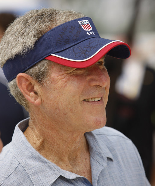 President George W. Bush sports a thank-you note on his visor, courtesy of the U.S. Beach Volleyball team as he watches practice Saturday, Aug. 9, 2008, at Chaoyang Park in Beijing. White House photo by Eric Draper