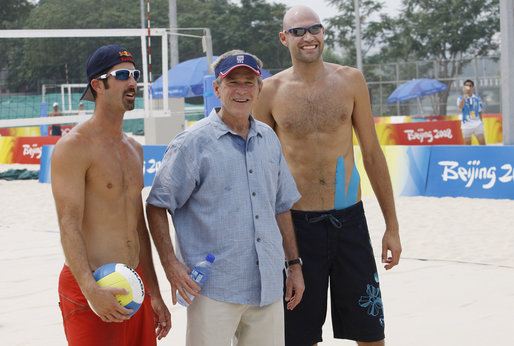 President George W. Bush pauses with U.S. Men's Beach Volleyball's Todd Rogers, left, and Philip Dalhausser as he visited the practice session Saturday, Aug. 9, 2008, at Beijing's Chaoyang Park prior to their first matches of the 2008 Summer Olympic Games. White House photo by Eric Draper