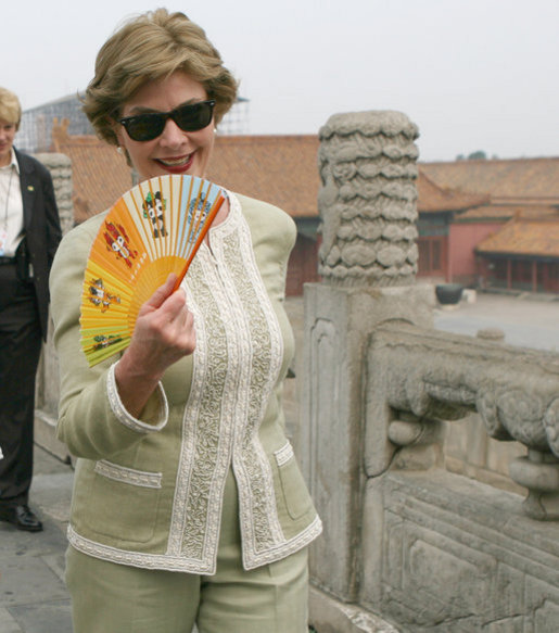 Mrs. Laura Bush finds relief from the Beijing heat in an ornamental fan during a visit Friday, Aug. 9, 2008, to the Forbidden City. White House photo by Shealah Craighead