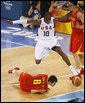 U.S. Olympic Men's Basketball team member Kobe Bryant leaps over a member of China's team chasing for a loose ball Sunday, Aug. 10, 2008, during action in the Group B men's Olympic basketball game between the U.S. and China, at the 2008 Summer Olympic Games in Beijing. White House photo by Eric Draper