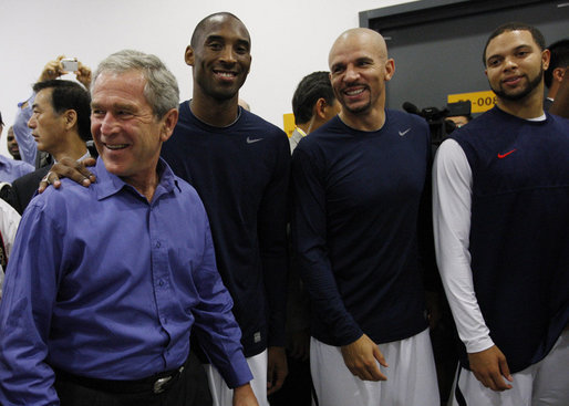 President George W. Bush spends a moment with U.S. Olympic Men's Basketball Team members, from left, Kobe Bryant, Jason Kidd and Deron Williams Sunday, Aug. 10, 2008, during a visit with the team prior to their game against China at the 2008 Summer Olympic Games in Beijing. White House photo by Eric Draper