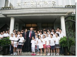 Standing with the Kuanjie Summer Vacation School Choir and Pastor Meng Maoru, President George W. Bush delivers a statement outside Beijing Kuanjie Protestant Christian Church in Beijing Sunday, Aug. 10, 2008. Said the President, "Laura and I just had the great joy and privilege of worshiping here in Beijing, China. You know, it just goes to show that God is universal, and God is love, and no state, man or woman should fear the influence of loving religion." White House photo by Chris Greenberg