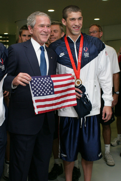 President George W. Bush poses for a photo with U.S. Olympic swimming gold medalist Michael Phelps during his visit Sunday, Aug. 10, 2008 to the National Aquatic Center in Beijing, where Phelps won his first Olympic gold medal in the men's 400 meter individual medley. White House photo by Shealah Craighead