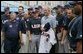 President George W. Bush poses for a photo with the U.S. Olympic men's baseball team and their manager Davey Johnson, right, prior to a practice game with the Chinese Olympic men's baseball team Monday Aug. 11, 2008, at the 2008 Summer Olympic Games in Beijing. The U.S. Olympic men's baseball team presented President Bush with a U.S. Olympic baseball hat and an autographed U.S. Olympic baseball jersey. White House photo by Chris Greenberg