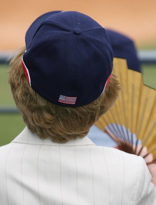 Mrs. Laura Bush wearing a U.S. Olympic baseball team hat watches the U.S. Olympic men's baseball team play a practice game against the Chinese Olympic men's baseball team Monday, Aug. 11, 2008, at the 2008 Summer Olympic Games in Beijing. White House photo by Shealah Craighead