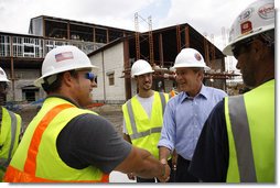 President George W. Bush meets with construction workers on his tour Wednesday, Aug. 20, 2008 of the historic Jackson Barracks of New Orleans, headquarters of the Louisiana National Guard. The barracks were seriously damaged in 2005 by Hurricane Katrina.  White House photo by Eric Draper