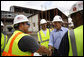President George W. Bush meets with construction workers on his tour Wednesday, Aug. 20, 2008 of the historic Jackson Barracks of New Orleans, headquarters of the Louisiana National Guard. The barracks were seriously damaged in 2005 by Hurricane Katrina. White House photo by Eric Draper