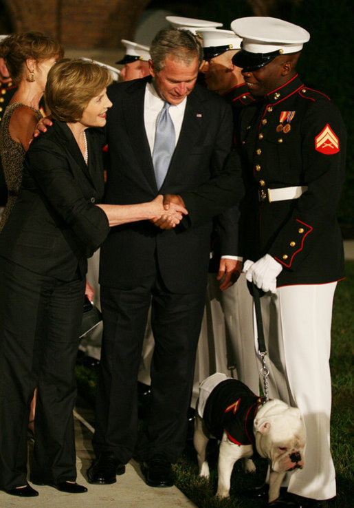 Mrs. Bush greets participants of the Evening Parade at the Marine Barracks, Friday, August 29, 2008 in Washington DC, as President George W. Bush looks down at the official barracks mascot, Chesty. White House photo by Joyce N. Boghosian