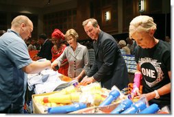Mrs. Laura Bush, joined by Mrs. Cindy McCain, right, help HIV and AIDS advocate Princess Kasune Zulu, left, and One Chairman and CEO David Lane assemble care-giver packages at the ONE campaign event Tuesday, Sept. 2, 2008 at the Minneapolis Convention Center in Minneapolis, in support of health care workers who treat AIDS paitients in African countries.  White House photo by Shealah Craighead