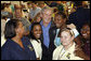 President George W. Bush stands with workers inside the Louisiana State Emergency Operations Center Wednesday, Sept. 3, 2008, in Baton Rouge. Speaking to all those who came to the aide in the wake of Hurricane Gustav, the President said, "I want to thank all the volunteers and the faith-based community that always rises up in a challenge like this. They listen to that universal call to love a neighbor. And that's happening here in Louisiana again." White House photo by Eric Draper
