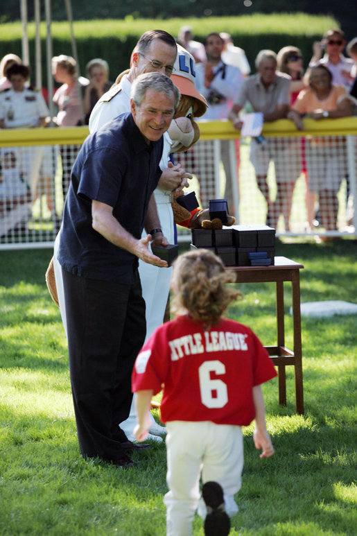 President George W. Bush greets Kassie Frank of Gaithersburg, Md. as he presents her with a baseball Sunday, Sept. 7, 2008, following the final game of Tee Ball on the South Lawn: A Salute to the Troops. White House photo by Grant Miller