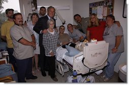 President George W. Bush stands with the extended family of U.S. Army Sgt. Jason Shepperly of Birmingham, Ala., during a visit Tuesday, Sept. 9, 2008, to Walter Reed Army Medical Center, where the soldier is recovering from wounds received during Operation Iraqi Freedom. White House photo by Eric Draper