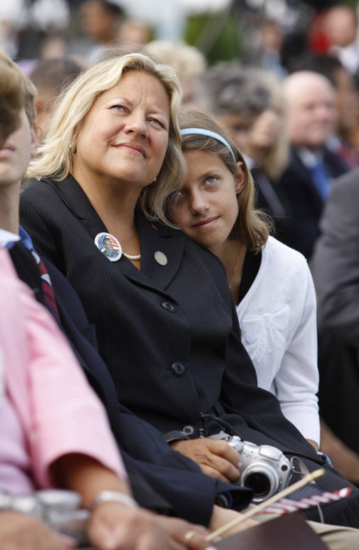 A young girl leans close to her mother during the dedication ceremony of the 9/11 Pentagon Memorial Thursday, Sept. 11, 2008, in Arlington, Va. White House photo by Eric Draper