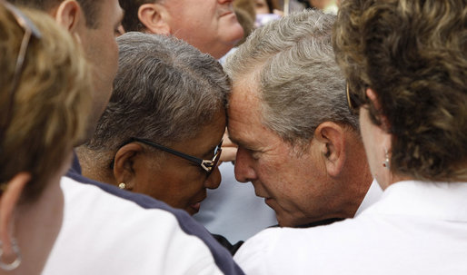 President George W.B ush embraces a family member during the Pentagon Memorial dedication ceremony Thursday, Sept. 11, 2008 at the Pentagon in Arlington, Va., where 184 memorial benches were unveiled honoring all innocent life lost when American Airlines Flight 77 crashed into the Pentagon on Sept. 11, 2001. White House photo by Eric Draper