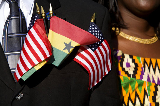 Flags of the United States and Ghana are displayed by a guest attending the South Lawn Arrival Ceremony for President John Agyekum Kufuor of Ghana Monday, Sept. 15, 2008, at the White House. White House photo by David Bohrer